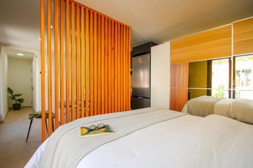 En eller flere senge i et værelse på Atico en el centro de Sevilla