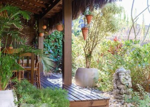 a garden with a porch with a potted plant at Casa Mar Villas in Florianópolis