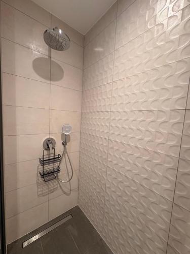 a bathroom with a shower with a glass wall at Signature 1 Bedroom at The Bantree Accra in Accra
