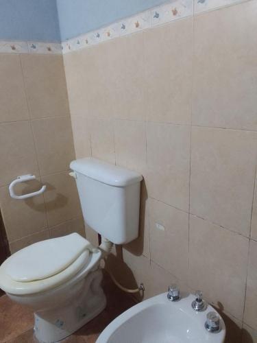 a bathroom with a white toilet and a sink at El Espinillo 2 in La Falda