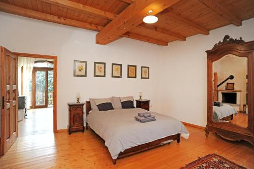 a bedroom with a bed and a large mirror at La casa dei Giardini, Bioglio in Bioglio