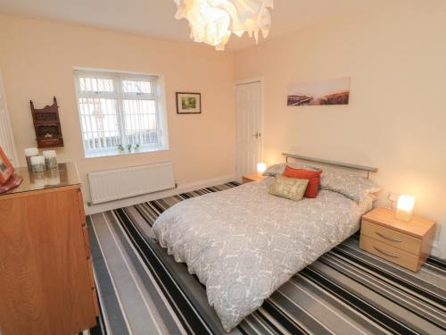 En eller flere senge i et værelse på Cliffe Cottage