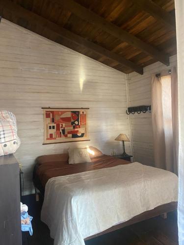 a bedroom with a large bed in a room at Cabaña in Punta Del Diablo