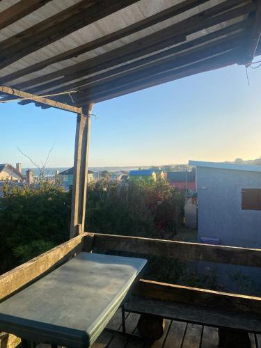 a picnic table sitting on top of a balcony at Cabaña in Punta Del Diablo