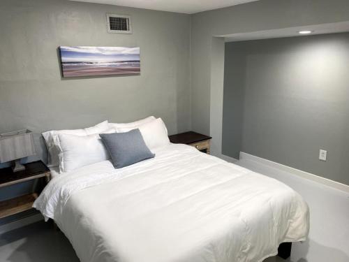 a bedroom with a white bed with a blue pillow at E 1st Back Casita in Tucson