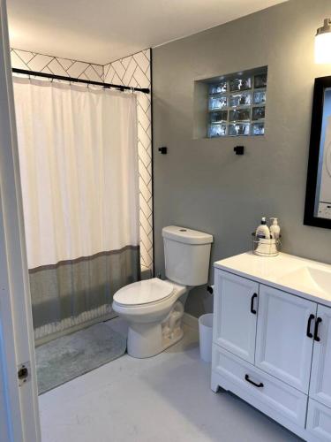 a bathroom with a toilet and a sink and a shower at E 1st Back Casita in Tucson