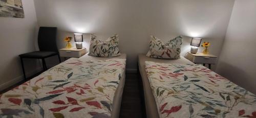 a bedroom with two beds with pillows on them at Ferienhaus Luisa 2 in Aurich