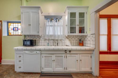 a kitchen with white cabinets and a sink at N 1st Ave in Tucson