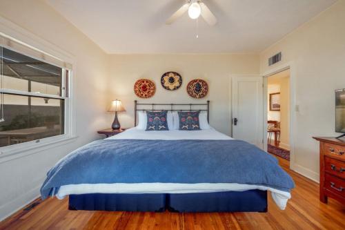 a bedroom with a blue bed and a window at Casita #7 in Tucson