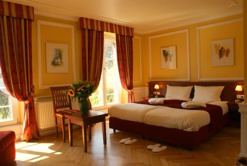 a bedroom with a bed and a window at Château de Pourtalès in Strasbourg