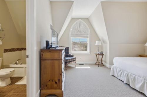 a bedroom with a bed and a sink and a window at 225 Snowbridge with Village Shuttle in Collingwood