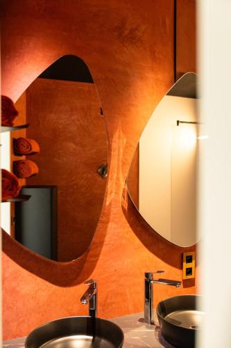 a bathroom with two sinks and a large mirror at Hortensia 7 in La-Roche-en-Ardenne