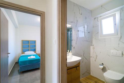 a bathroom with a sink and a toilet and a tub at Breeze Apartment Nikiti in Nikiti