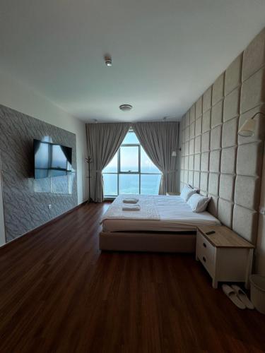Sand And Beachfront Havens with sea view&pool&Gym&jacuzz في عجمان: غرفة نوم بسرير كبير ونافذة كبيرة