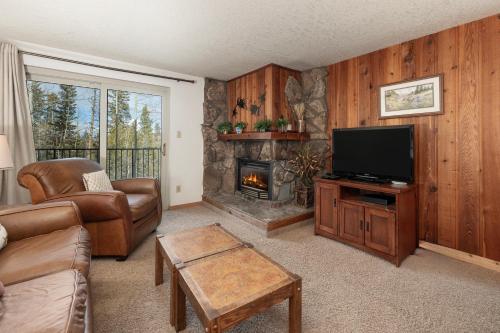a living room with a television and a fireplace at Beaver Village Unit #0724 in Winter Park