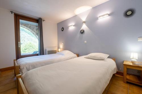 Ένα ή περισσότερα κρεβάτια σε δωμάτιο στο Gîte Logement 2/4 personnes - Village de gites des Vignes