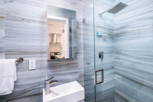 a bathroom with a sink and a mirror at Beautiful Key Largo Escape Pool, Tennis & Marina in Key Largo
