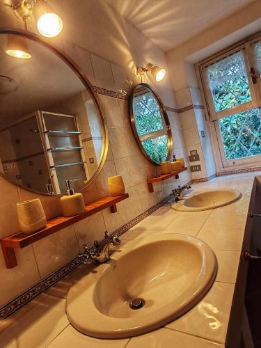 a bathroom with two sinks and a large mirror at Sunrise in Rapallo