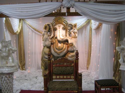 a large statue of an elephant sitting on a bed at La Mercy Beach Hotel in La Mercy