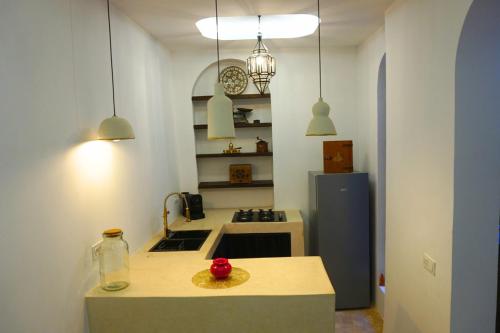 a kitchen with a counter top and a refrigerator at Little date in Marrakech