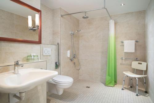 a bathroom with a sink and a toilet and a shower at Das Karl in Ingelheim am Rhein