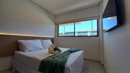 En eller flere senge i et værelse på Cond Pe na Areia com Piscina Privativa