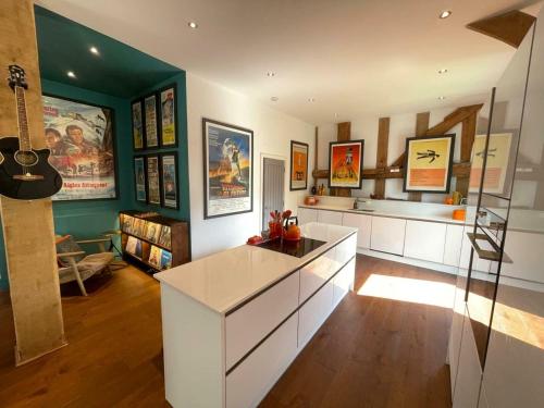 a kitchen with a white island in a room at Entertainment Packed 3BDR Barn at Stevenage in Shephall