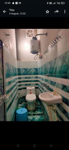 a bathroom with a toilet and a sink at Manglam House in Ayodhya
