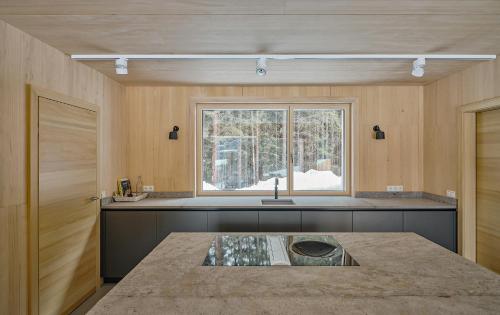 a kitchen with a sink and a window at Z91 - Skandi-Architektenhaus mit Bergblick in Bad Mitterndorf