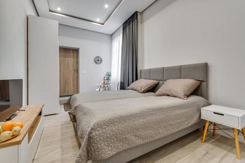 a bedroom with a large bed and a table at Central Platinum Apartments 27 in Rybnik