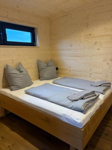 a bedroom with two beds in a wooden cabin at Ferienresort Edersee GmbH in Hemfurth-Edersee