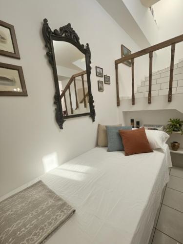 a mirror on the wall above a bed in a room at Characterful 2-Bed Home in Peaceful Town Near Agios Nikolaos in Neápolis