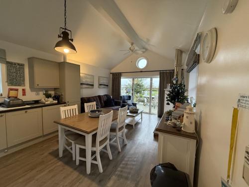 a kitchen and living room with a table and chairs at Mariners, The Bay, 2 bedrooms with ensuites, parking nearby, 1 medium or 2 small dogs welcome in Filey