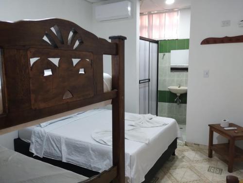 a bedroom with a bunk bed and a bathroom at La Quinta INN in Santa Marta