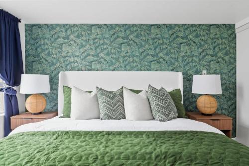 Tropical Designer King Suite - Sleeps 5 - Parking في ميسيساوغا: غرفة نوم بسرير اخضر ومصباحين