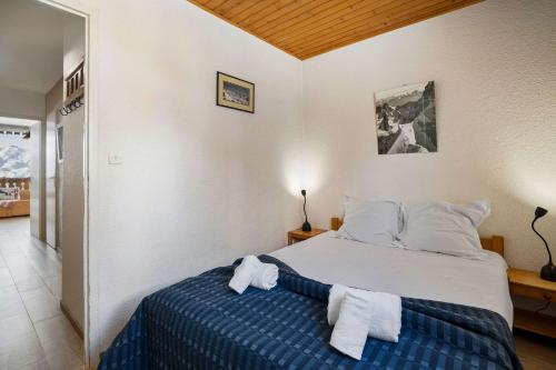 a bedroom with a bed with towels on it at Ski-in Chalet-Style View Flat - Résidence les Eterlous in Val Thorens