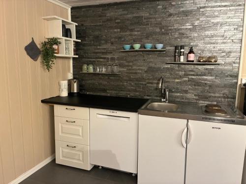 a kitchen with white cabinets and a sink at Leilighet i hus in Sarpsborg