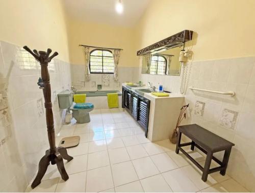 a bathroom with a sink and a toilet in it at Paradise Garden watamu in Watamu