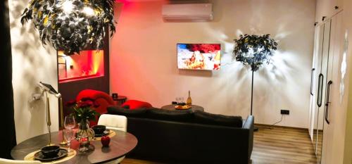 a living room with a table and a couch at Red Room Luxury puhkemaja 