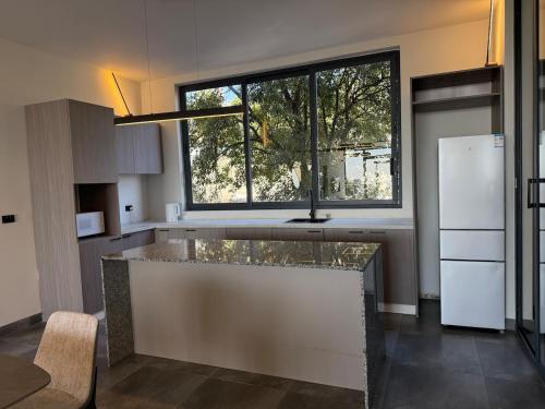 a kitchen with a counter with a large window at Chic & Cozy Designer Space 1A in Addis Ababa