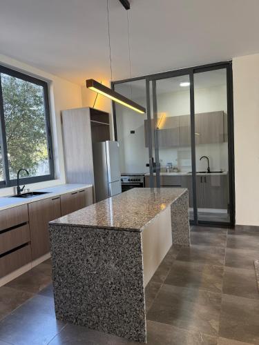 a kitchen with a island in the middle of a room at Chic & Cozy Designer Space 1A in Addis Ababa