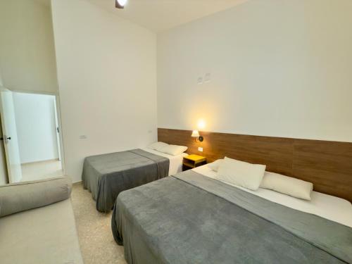 En eller flere senge i et værelse på Juquehy Studios 6