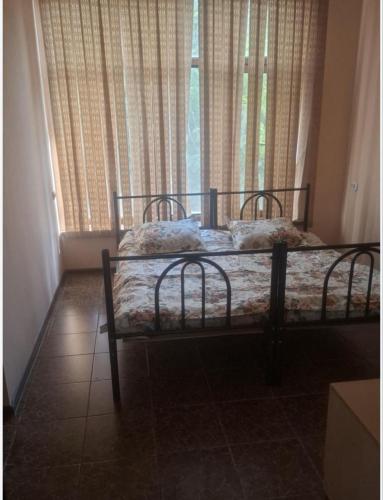 a bedroom with two beds in front of a window at Anissa in Shymkent
