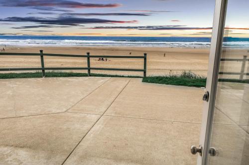 a view of the beach from the window of a building at Oceanfront Studio - Ground Floor - Sleeps 4 in Lincoln City