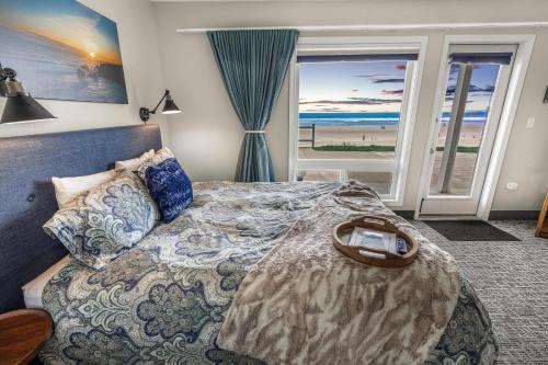 Un dormitorio con una cama con vistas a la playa. en Oceanfront Studio - Ground Floor - Sleeps 4, en Lincoln City