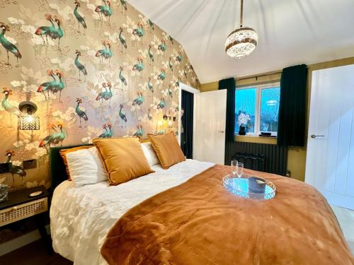 a bedroom with a large bed with a wall covered in dinosaurs at The Annexe in Yeovil Junction