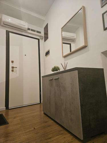 a mirror on a wall next to a door at A due passi dal centro in Castelfidardo