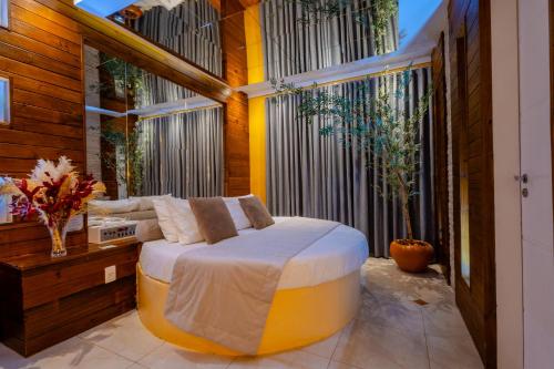 a bedroom with a large bed and a large window at Hotel Motel Paradiso - Tapera-RS in Tapera