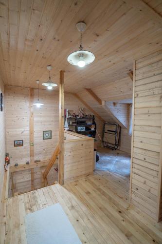 a large room with wooden walls and wooden flooring at Brvnara Moj san - Log cabin My Dream in Zelin Mrzlovodički
