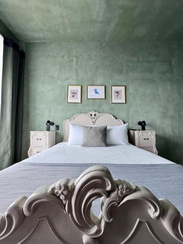 a bedroom with a bed with a white headboard at Lusitania Hotel Orizaba in Orizaba